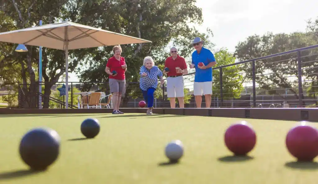 KT bocce2-image-blog-seo-WEBP Residents playing bocce ball at one of 6 dedicated courts at Kissing Tree