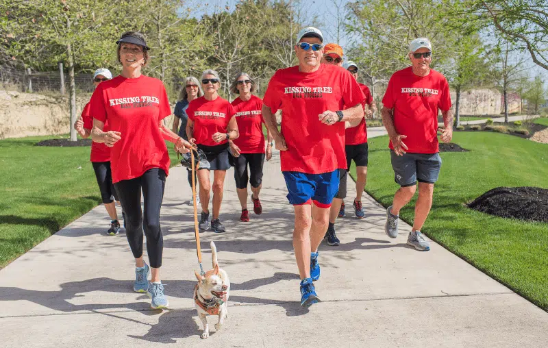 Kissing Tree residents running together with a dog
