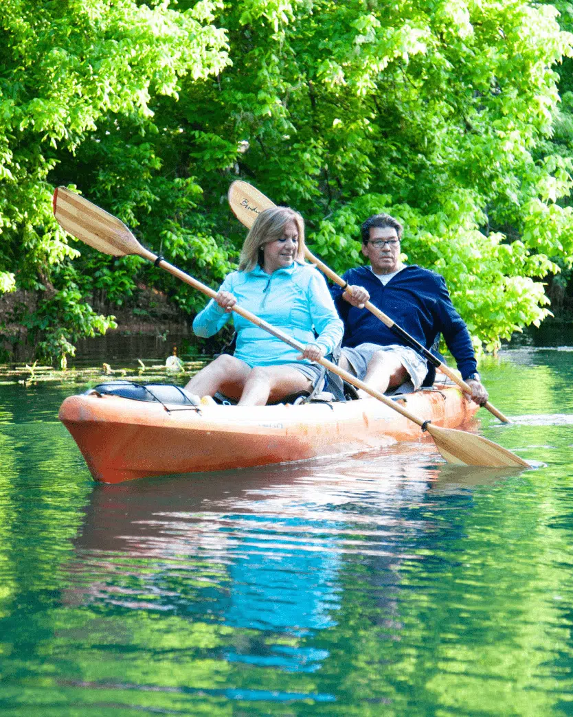 Couple inside of a small boat on a river