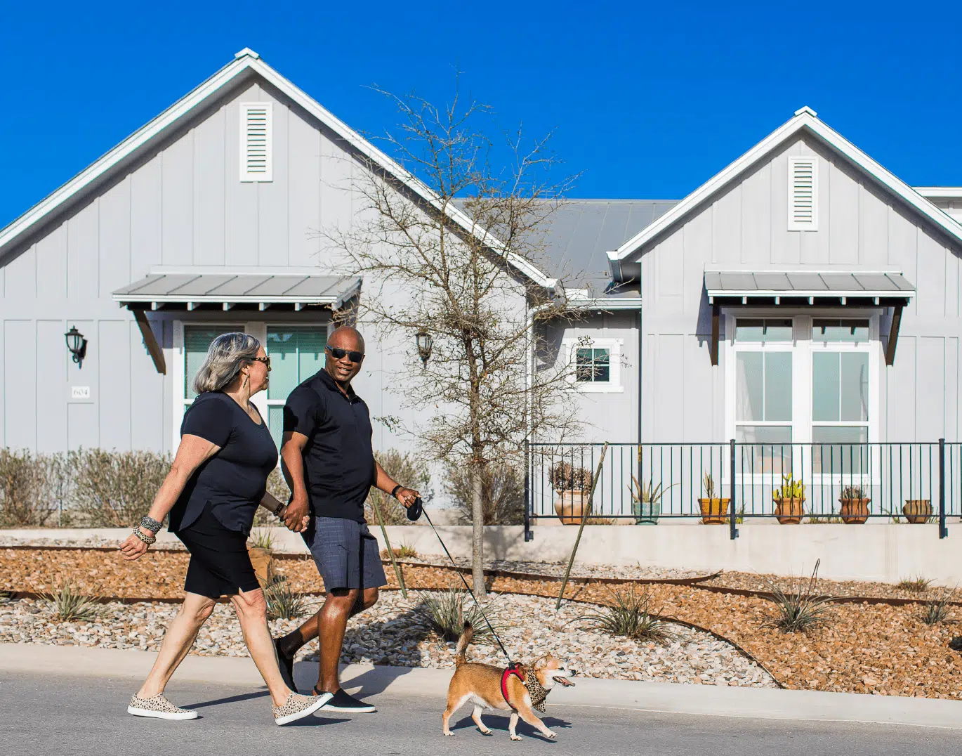 Homes and couple walking near by