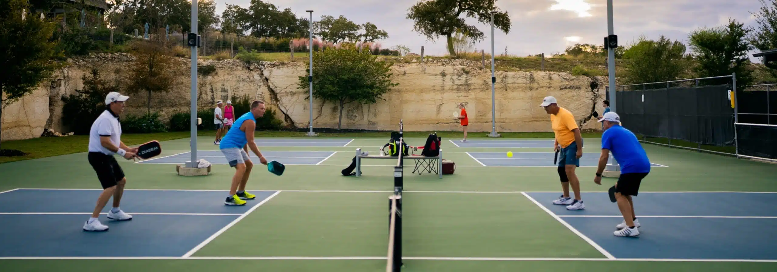 people playing pickleball at kissing tree